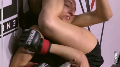 Headscissors MMA Fight. Female MMA fighter taps out her opponent with legscissors..jpeg